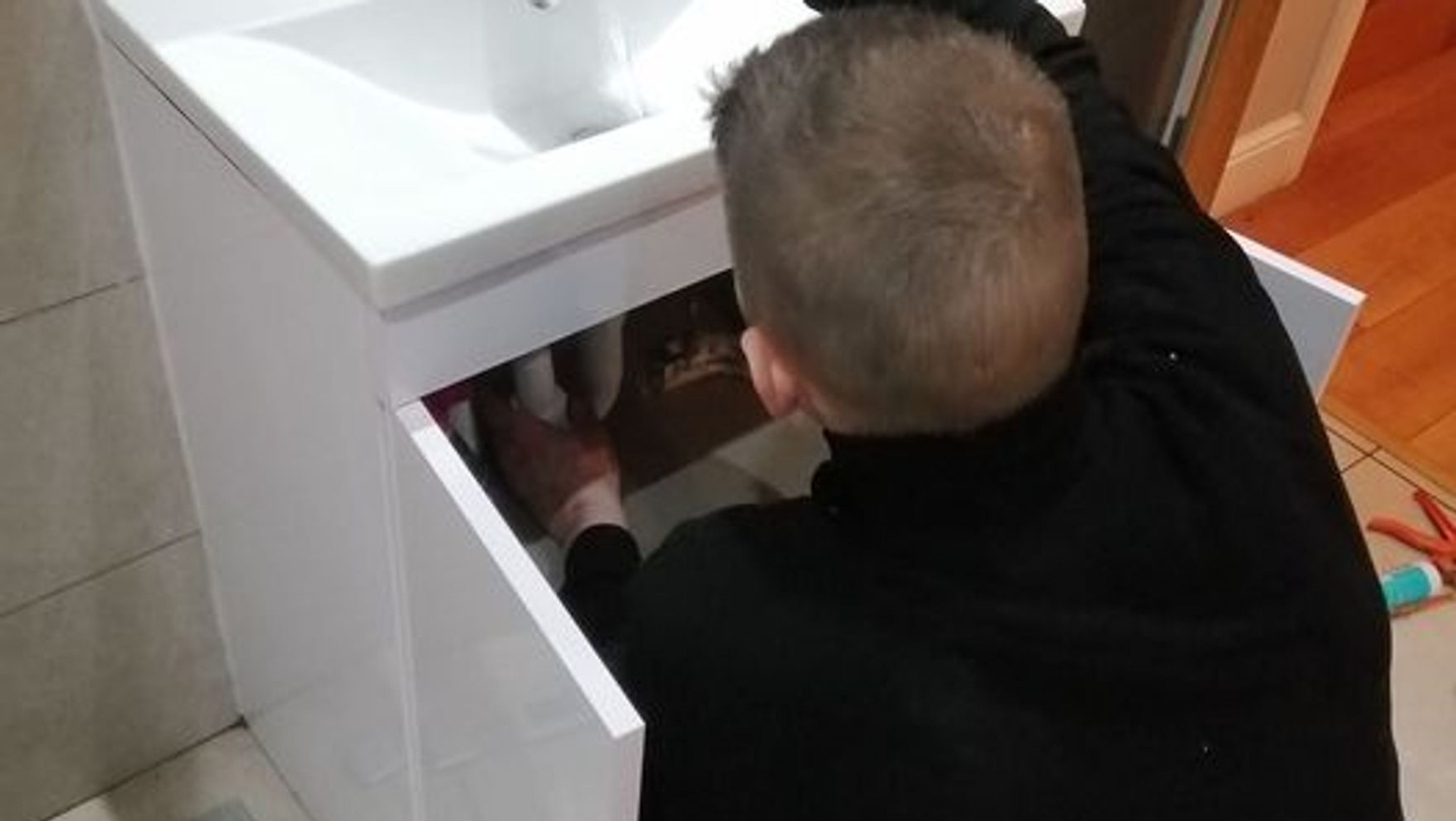 Professional plumbing tools including pipe wrench, copper fittings, PTFE tape, and pipe cutter neatly arranged on a navy cloth, showcasing the readiness and competence of Leeds Emergency Plumbers